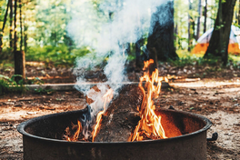 A campfire burning in a metal enclosure.