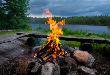 A campfire near a lake.
