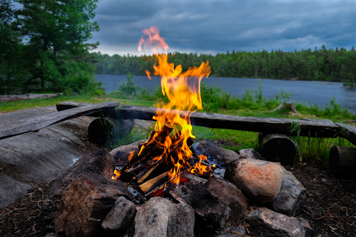 A campfire near a lake.