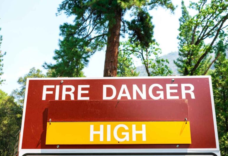 A wildfire season status sign that reads "FIRE DANGER HIGH".